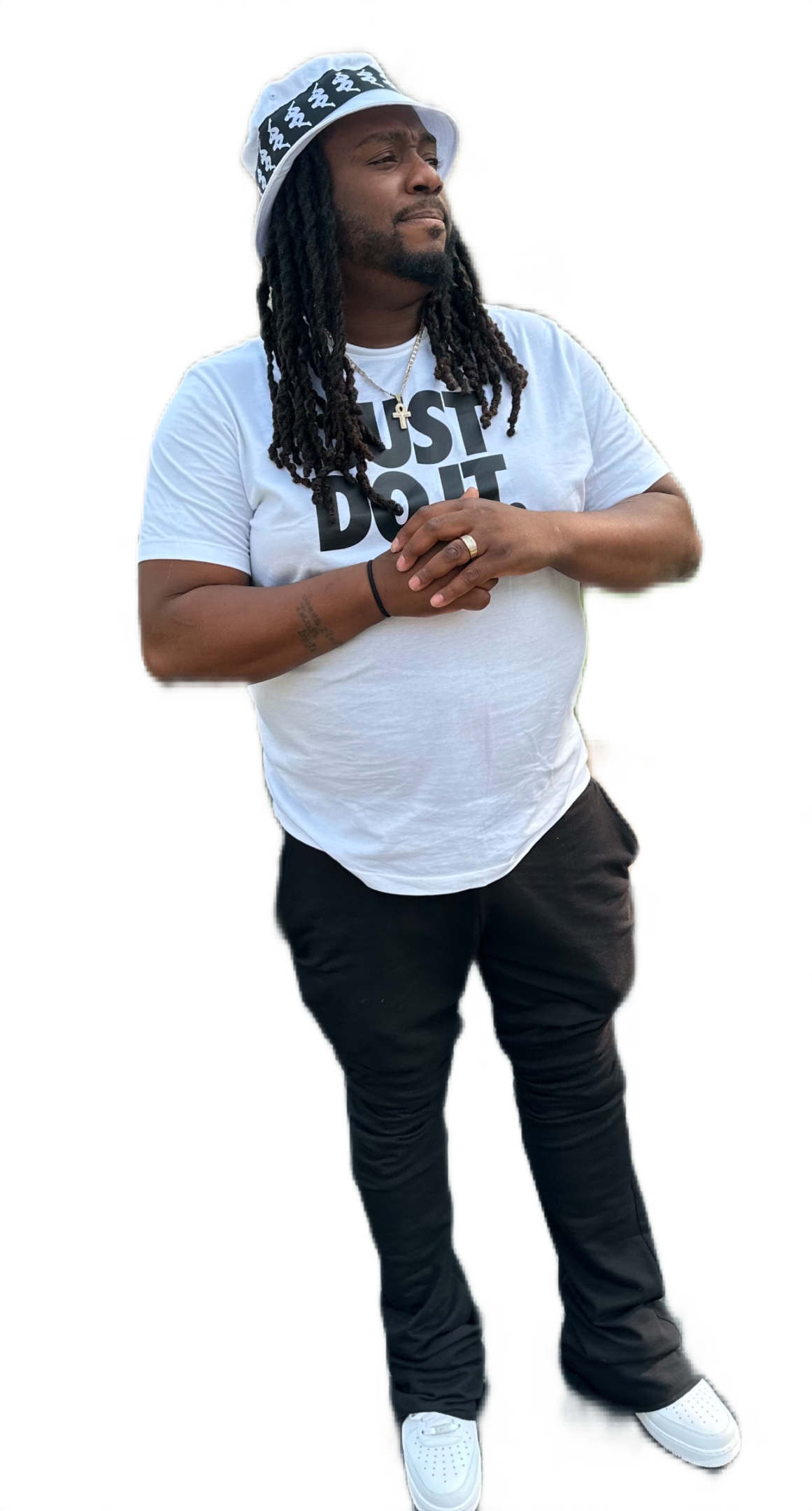 Person wearing a white shirt and black pants with hands clasped.