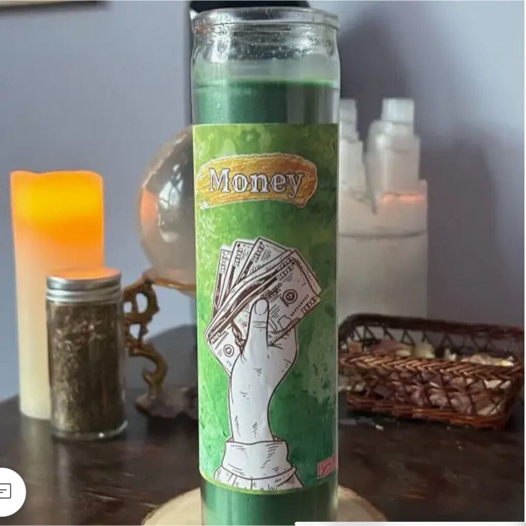 Green candle with a white dog illustration on a table.