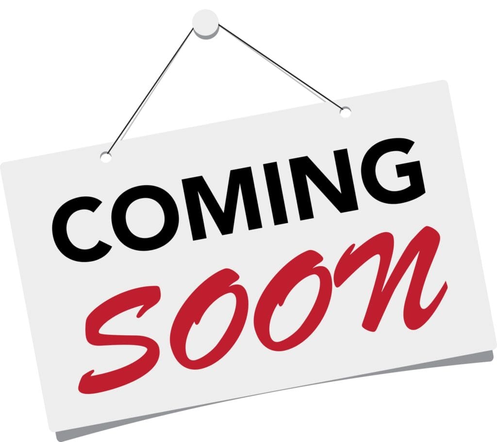 A hanging sign with the words 'COMING SOON' in bold black and red letters.